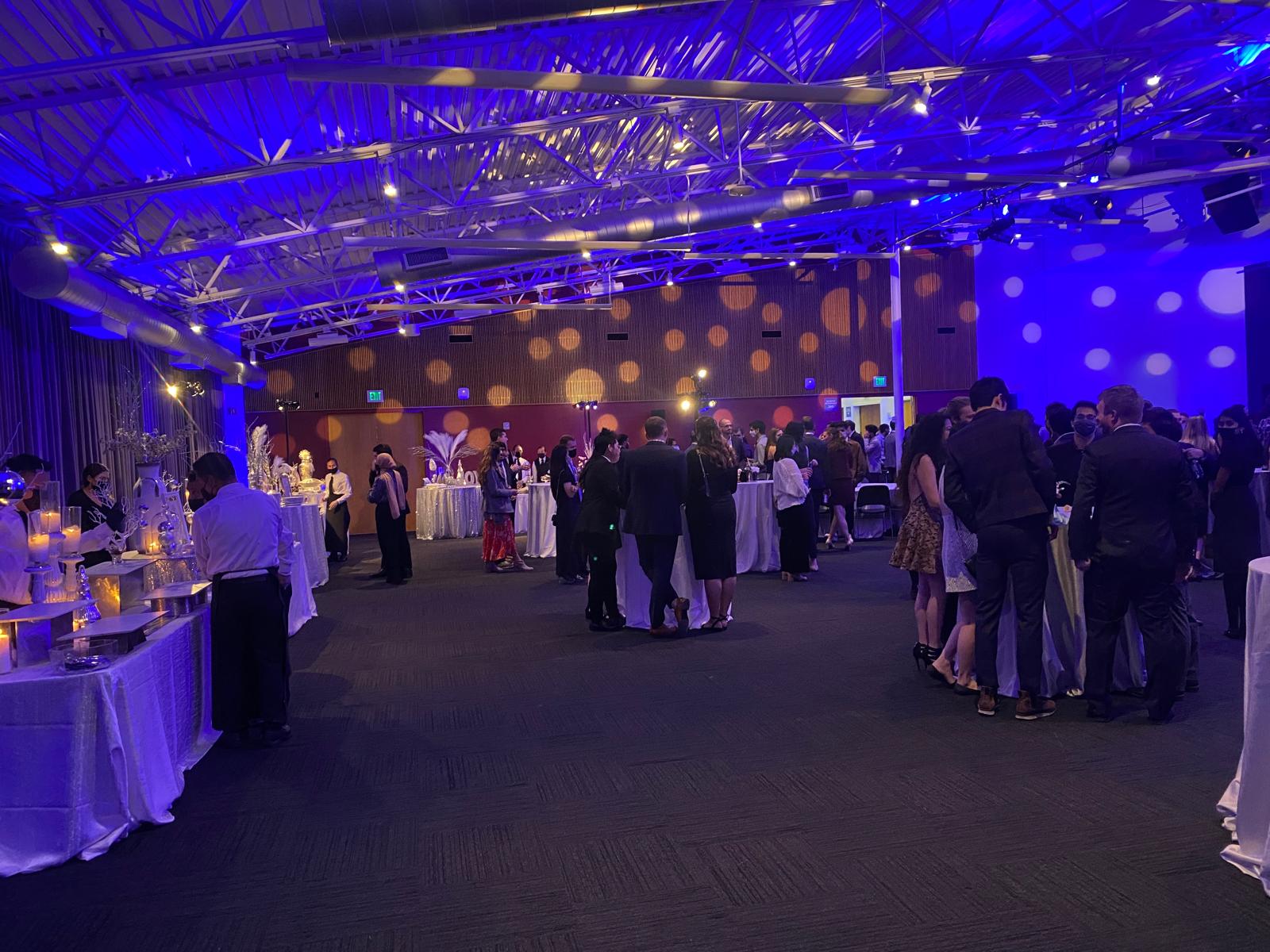 Guests gathered around chef-attended stations at a Bay Area corporate holiday party catered by PSRT